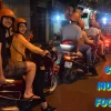 People on motorbikes enjoying street food in Saigon, Vietnam